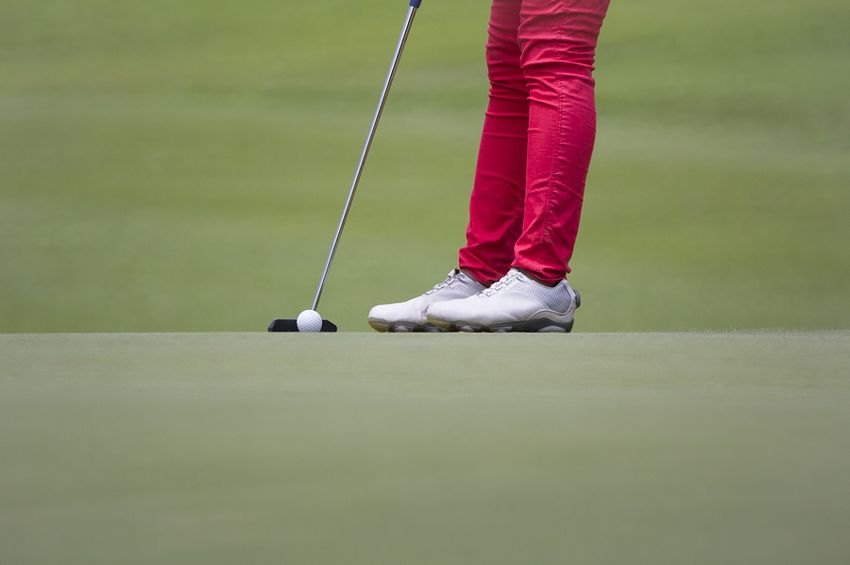 Legs of Female Golfer Putting