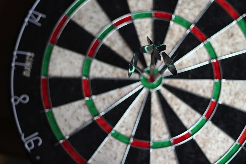 Dartboard with three darts in the centre